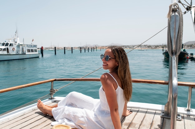 Free Photo side view beautiful young woman relaxing in her vacation