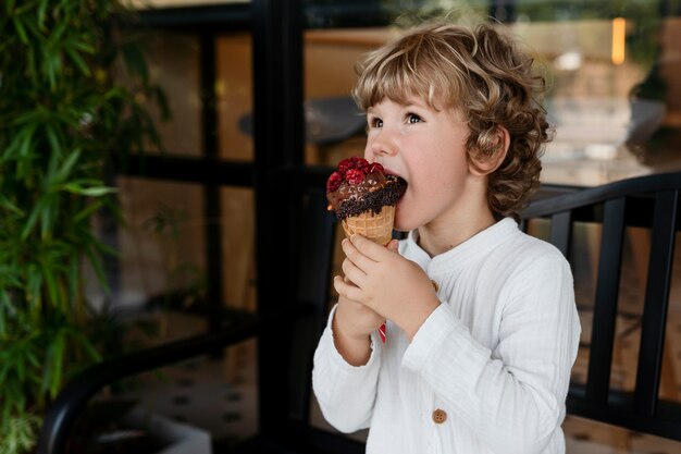 Side view boy licking ice cream cone