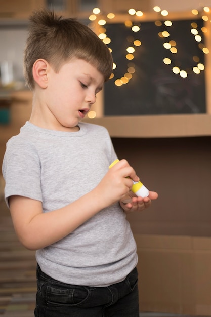 Free photo side view boy with glue