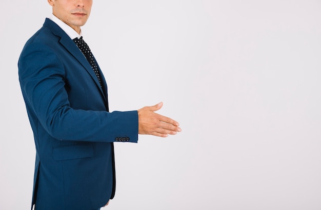 Free photo side view of businessman reaching out hand