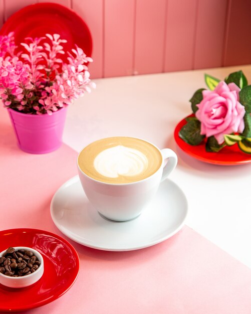 Side view cappuccino coffee with a heart shaped foam decor