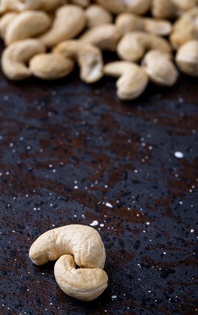 Side view of cashews on black background