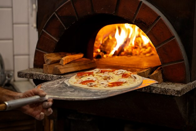 Side view chef baking delicious pizza