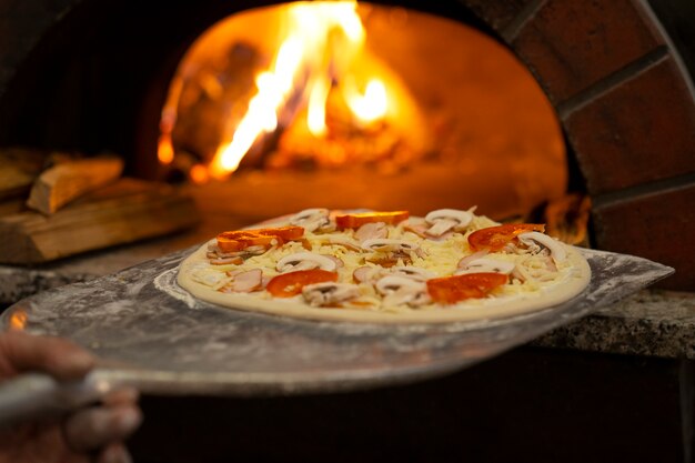 Side view chef baking delicious pizza