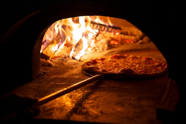 Side view chef baking delicious pizza