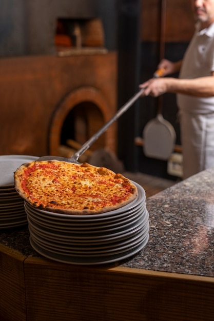 Side view chef preparing pizza