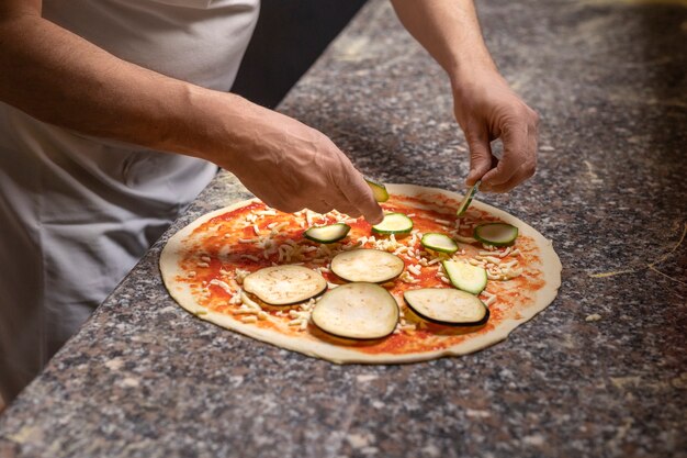 Side view chef preparing pizza