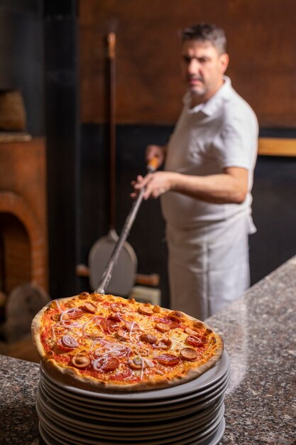 Side view chef preparing pizza