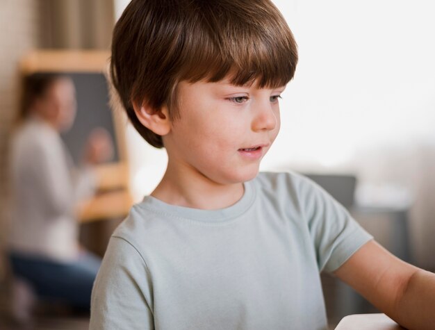 Side view of child being tutored at home