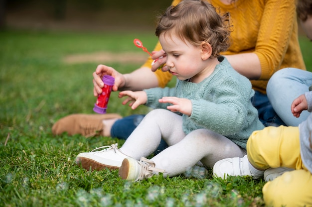 Side view of child outdoors in the park with lgbt mothers