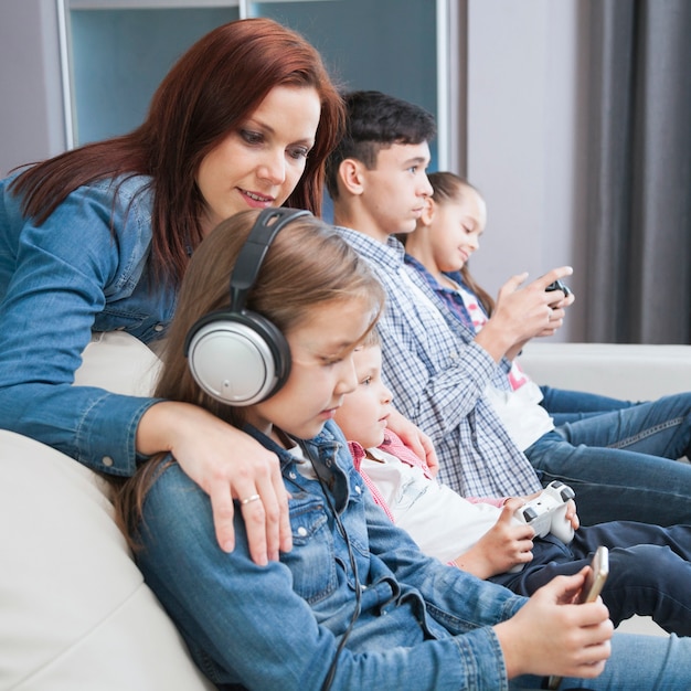 Side view children with technologies and mother