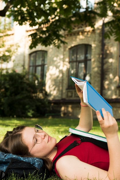 Free Photo side view close up of school girl reading a book