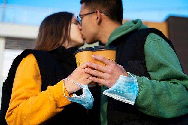 Side view couple kissing outdoors