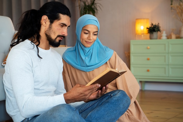 Side view couple reading book together