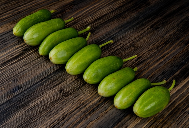 Free photo side view of cucumbers on wooden table