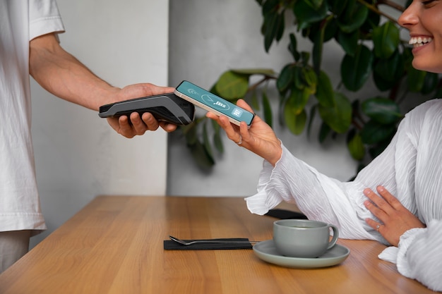 Free Photo side view customer paying with nfc device