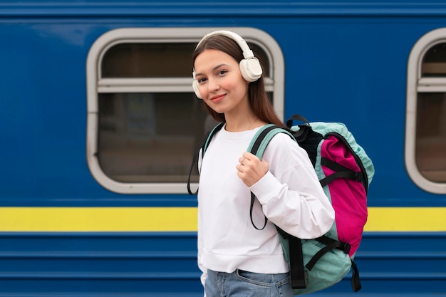 Side view cute girl at the railway station smiles