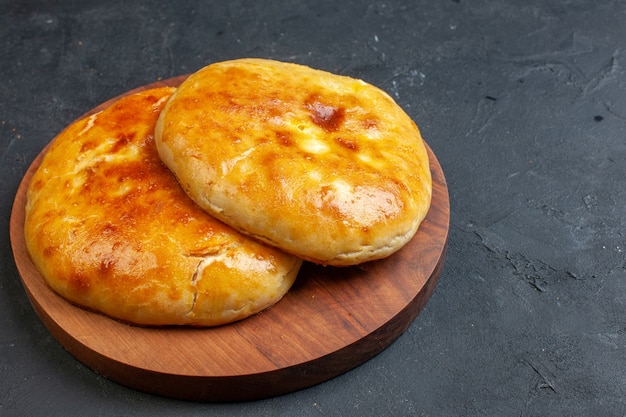 Side view of delicous fresh baked pastries on the right side on dark blackground