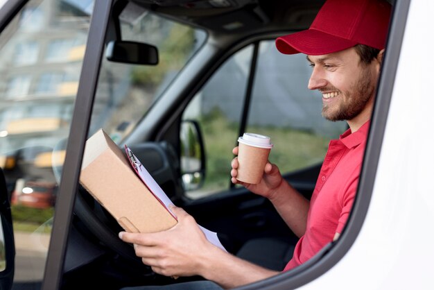 Side view delivery man with coffee