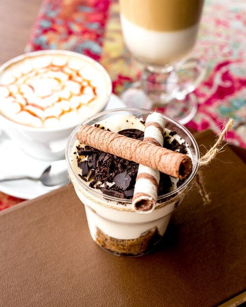 Side view dessert tiramisu with wafer rolls