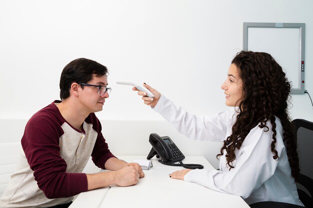 Side view doctor checking patient