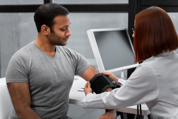 Free Photo side view doctor checking patient