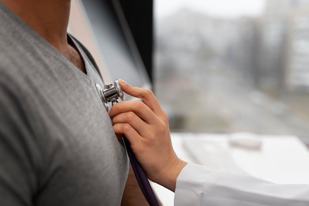 Side view doctor checking patient