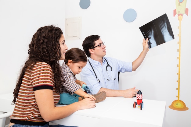 Side view doctor holding a radiography