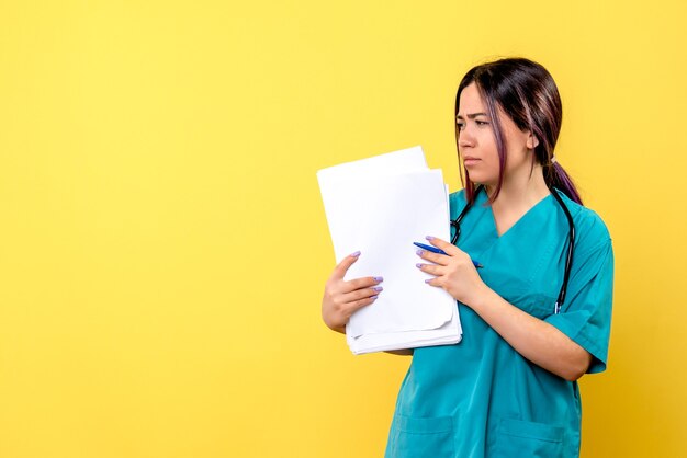 Side view of a doctor in medical uniform with pen and papers