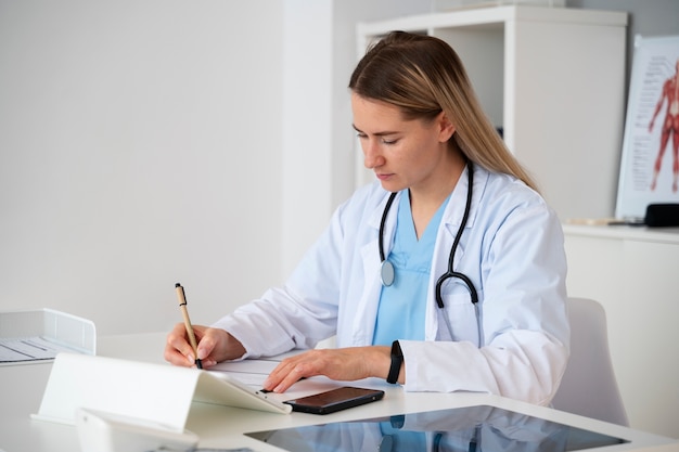 Side view doctor writing with pencil