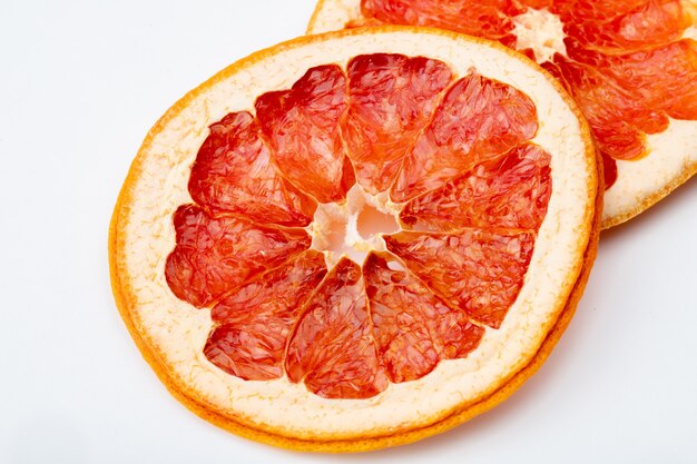 Side view of dried orange slices isolated on white background