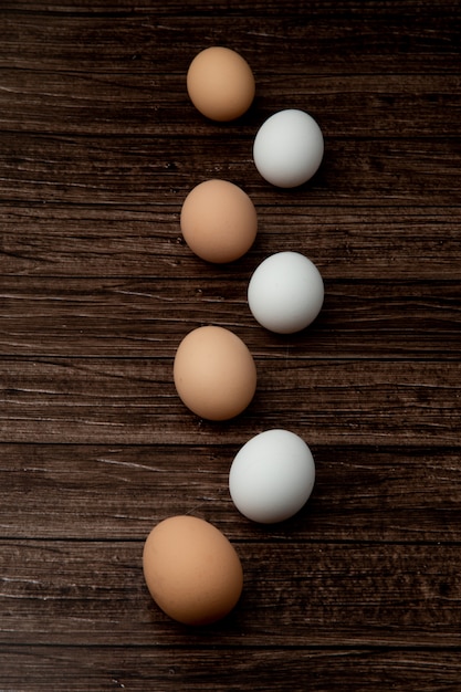 Side view of eggs on wooden background