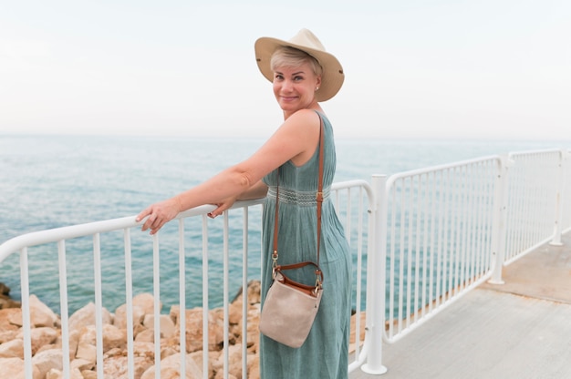 Side view of elder tourist woman at the beach