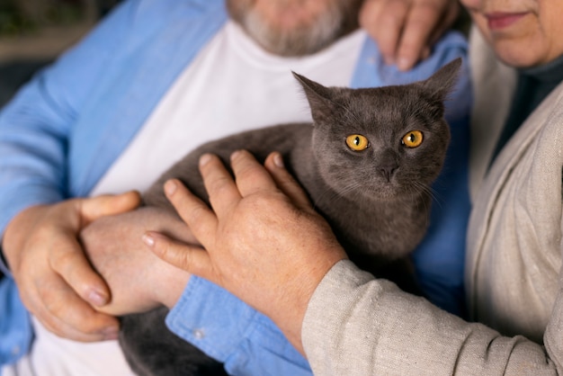 Free Photo side view elderly people with cat