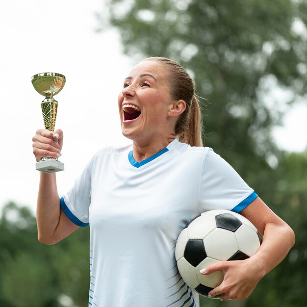 Side view excited woman holding prize