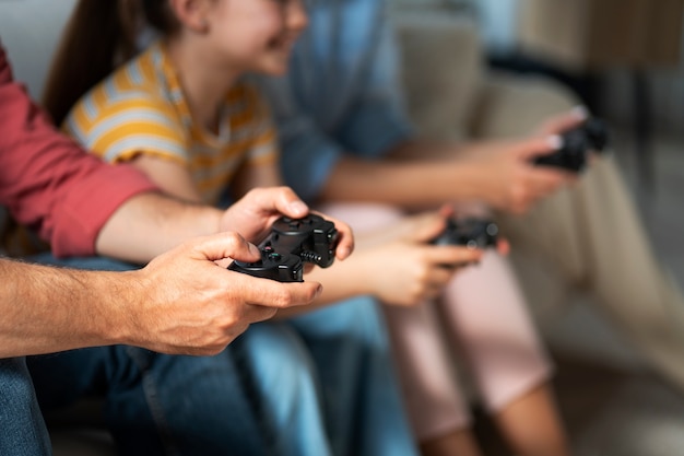 Free Photo side view family playing videogame