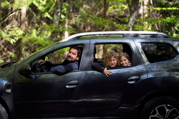 Side view family traveling by car