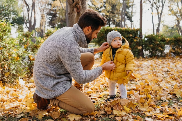 Side view of father spending time with his baby outdoors