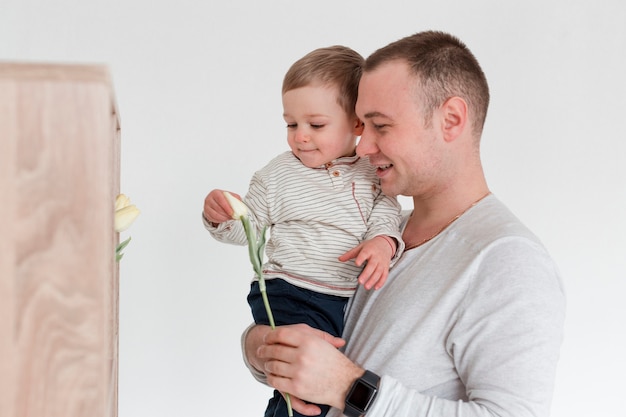 Free Photo side view of father with child holding father