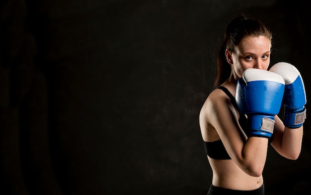 Side view of female boxer posing with copy space