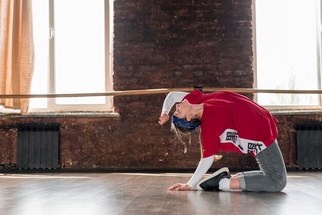 Side view of a female dancer doing practice in the dance studio