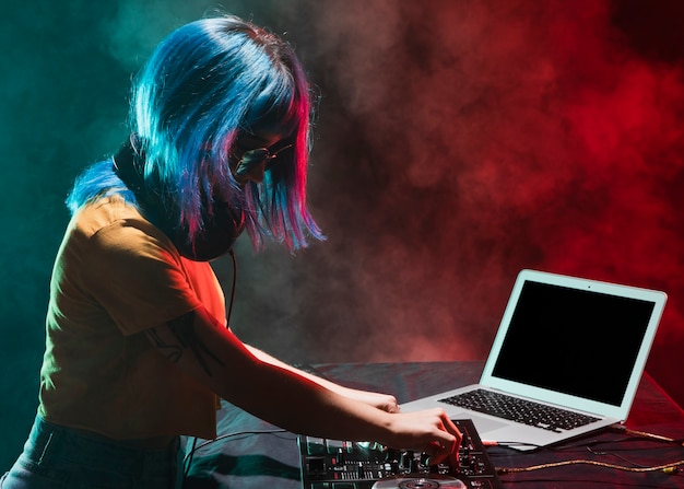 Side view female dj in club mixing