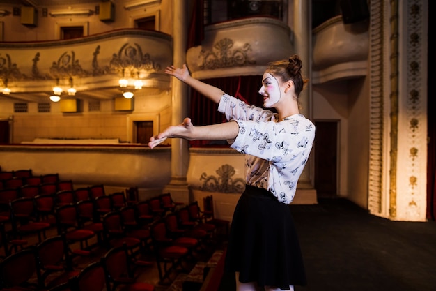 Side view of female mime rehearsing on stage