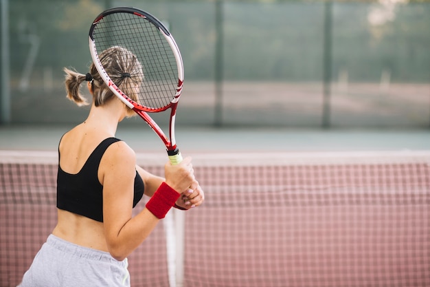 Side view female tennis player practicing