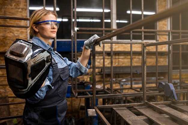 Side view of female welder at work