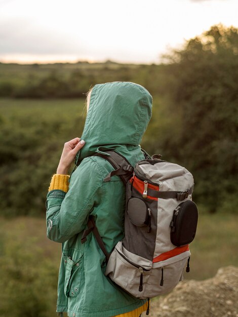 Side view female with backpack at sunset