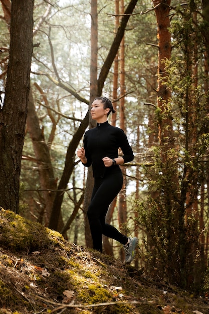 Side view fit woman running in nature