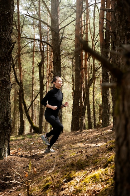 Side view fit woman running outside