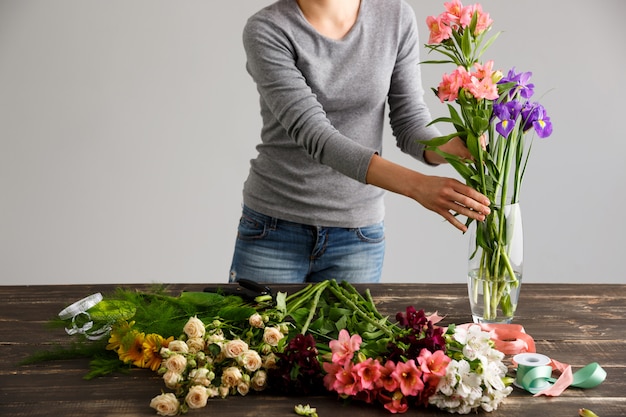 Free Photo side view of flowers, florist put bouquet in vase