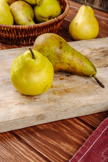 Side view of fresh ripe pears on a wooden cutting board